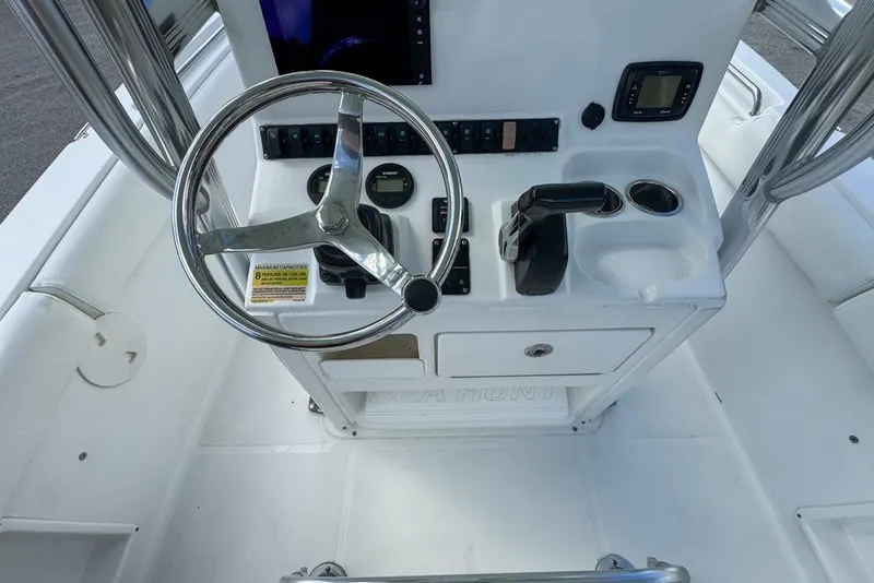 Slide: The Image of 2016 Sea Hunt Ultra 211 boat console with steering wheel and controls. - 39