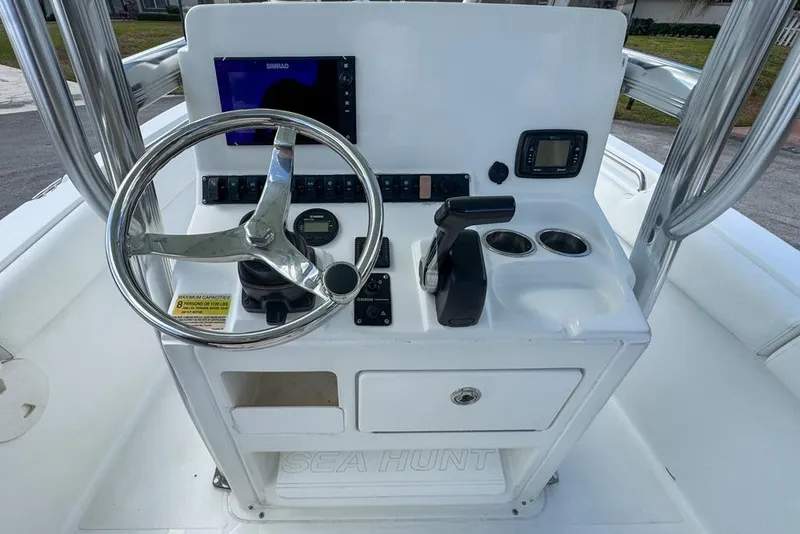 Slide: The Image of 2016 Sea Hunt Ultra 211 boat console with steering wheel and navigation controls. - 40