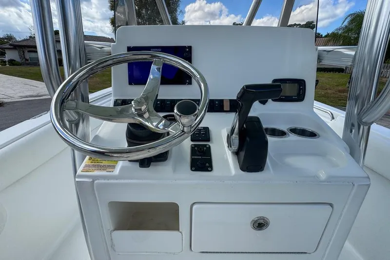 Slide: The Image of 2016 Sea Hunt Ultra 211 boat console with steering wheel and controls. - 41