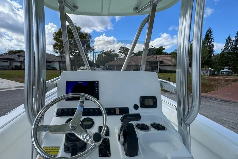 Slide: The Image of 2016 Sea Hunt Ultra 211 boat console with steering wheel and navigation equipment. - 42