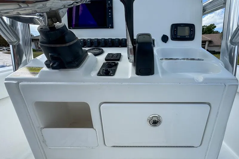 Slide: The Image of 2016 Sea Hunt Ultra 211 boat console with controls and navigation equipment. - 43