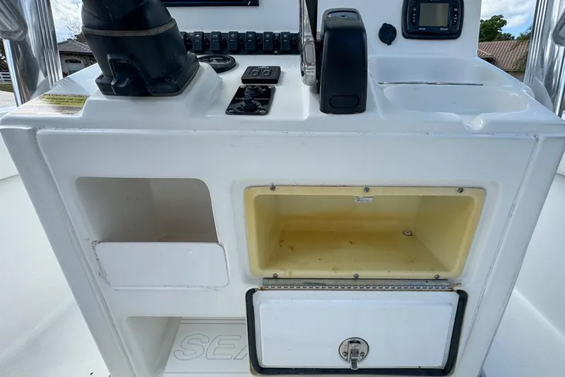 Slide: The Image of 2016 Sea Hunt Ultra 211 boat console with storage compartments and control panel. - 44
