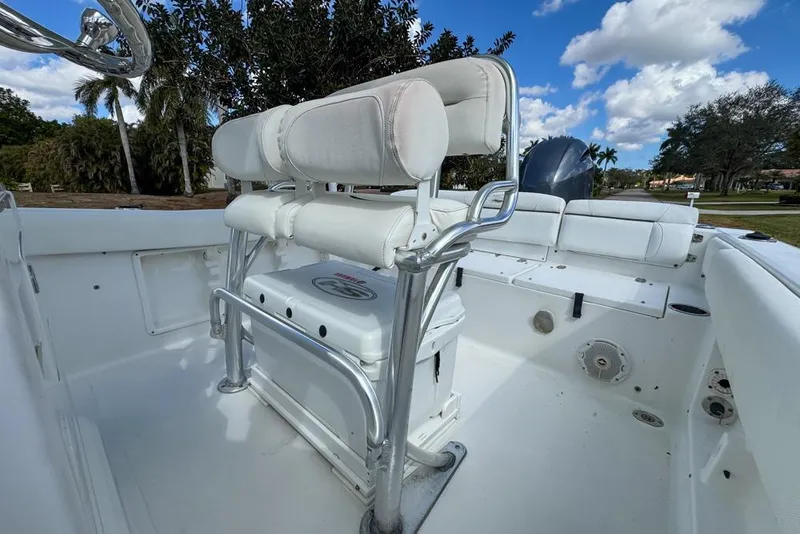 Slide: The Image of 2016 Sea Hunt Ultra 211 boat interior with white seating and chrome details. - 45