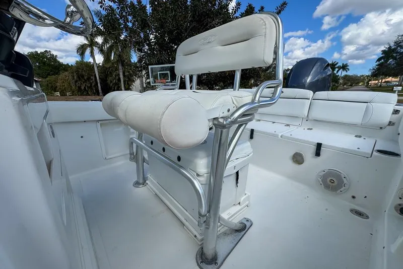 Slide: The Image of 2016 Sea Hunt Ultra 211 boat interior with white seating and steering console. - 46