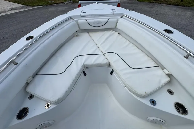 Slide: The Image of 2016 Sea Hunt Ultra 211 boat interior with white cushioned seating. - 48