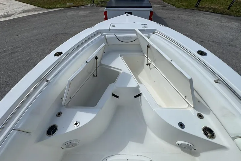 Slide: The Image of 2016 Sea Hunt Ultra 211 boat with open storage compartments on deck. - 52