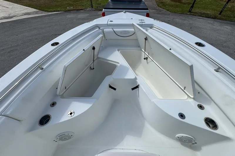 Slide: The Image of 2016 Sea Hunt Ultra 211 boat with open storage compartments on deck. - 53