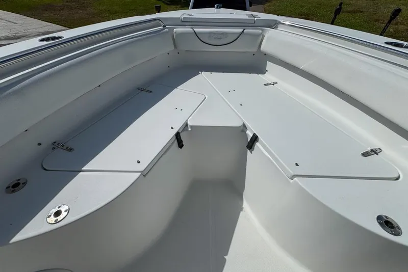 Slide: The Image of 2016 Sea Hunt Ultra 211 boat interior with white seating and storage compartments. - 55