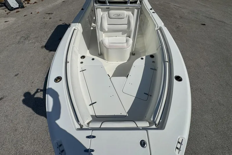 Slide: The Image of 2016 Sea Hunt Ultra 211 boat interior with white seating and storage compartments. - 62