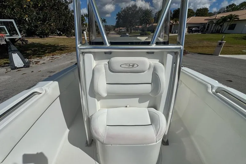 Slide: The Image of 2016 Sea Hunt Ultra 211 boat interior with white seating and stainless steel frame. - 72