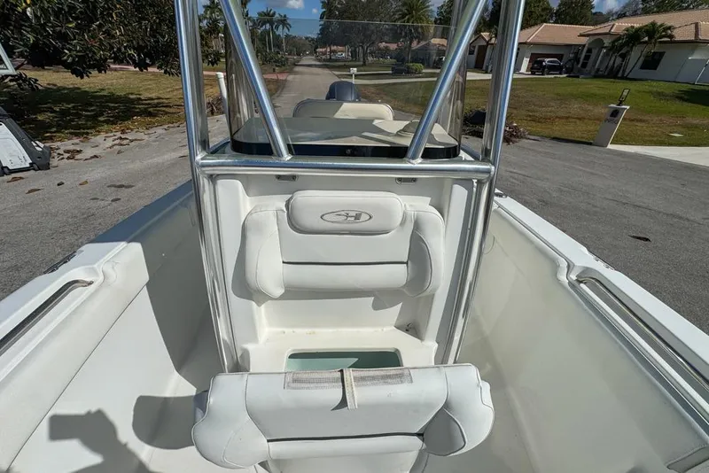 Slide: The Image of 2016 Sea Hunt Ultra 211 boat interior with white seating and stainless steel frame. - 75