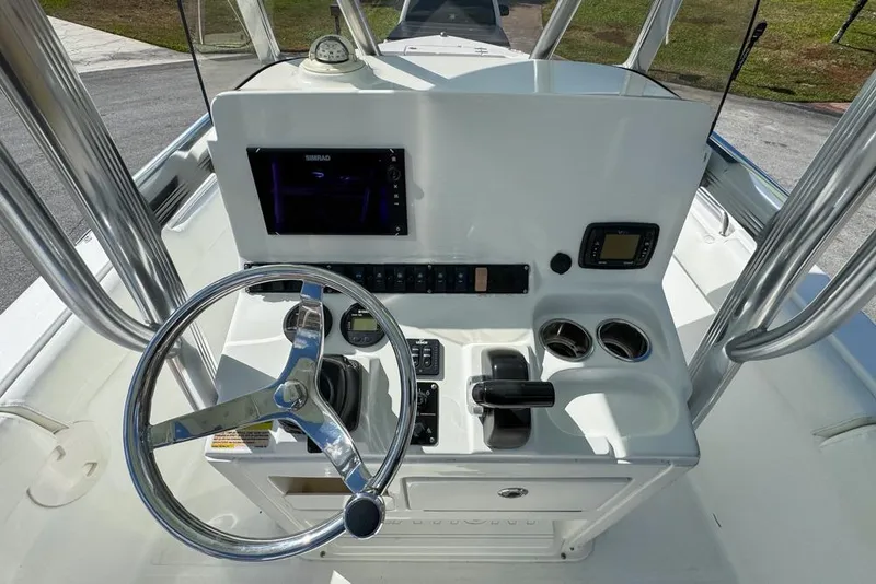 Slide: The Image of 2016 Sea Hunt Ultra 211 boat console with steering wheel and navigation controls. - 82