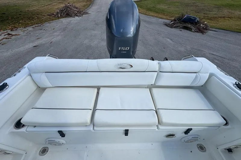 Slide: The Image of 2016 Sea Hunt Ultra 211 boat with Yamaha 150 engine, featuring white cushioned seating. - 85