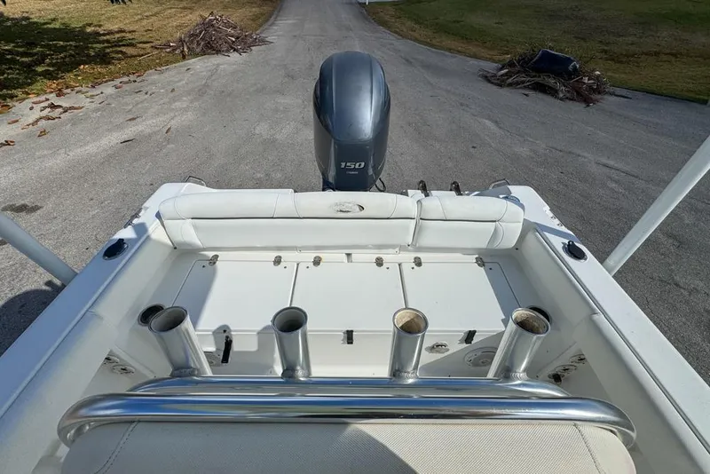 Slide: The Image of 2016 Sea Hunt Ultra 211 boat with Yamaha 150 engine, featuring rod holders and seating. - 88