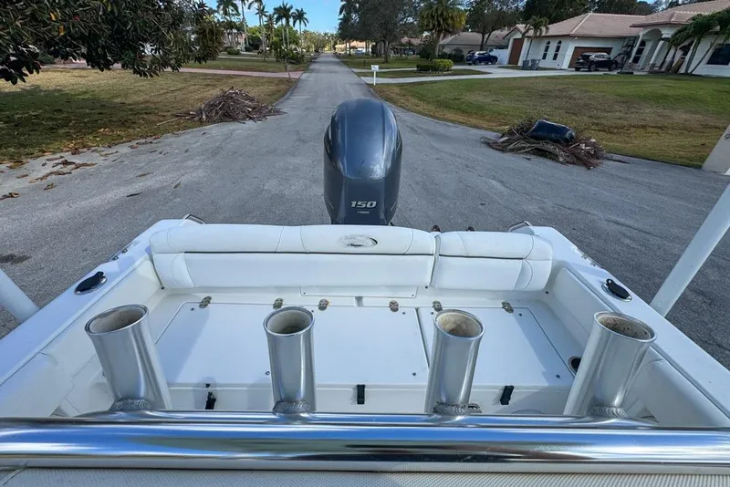 Slide: The Image of 2016 Sea Hunt Ultra 211 boat with Yamaha 150 engine, parked on residential street. - 90