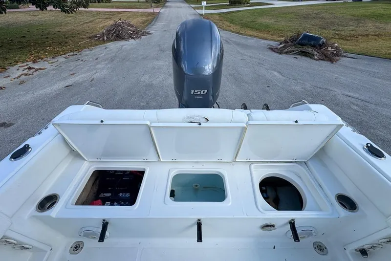 Slide: The Image of 2016 Sea Hunt Ultra 211 boat with open storage compartments and Yamaha 150 engine. - 92