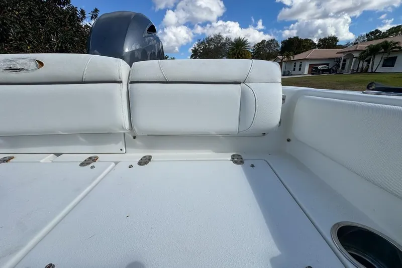Slide: The Image of 2016 Sea Hunt Ultra 211 boat interior with white seating and storage compartments. - 93