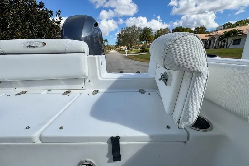 Slide: The Image of 2016 Sea Hunt Ultra 211 boat interior with white seating and clear sky background. - 94