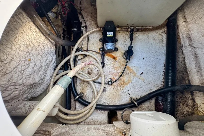 Slide: The Image of Bilge area of a 2016 Sea Hunt Ultra 211 boat with hoses and pump. - 95