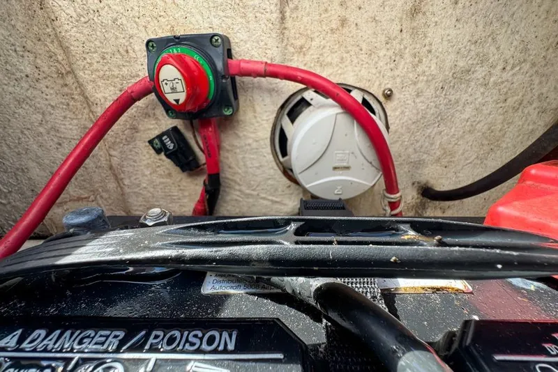 Slide: The Image of Battery compartment of a 2016 Sea Hunt Ultra 211 boat with wiring and switch. - 98