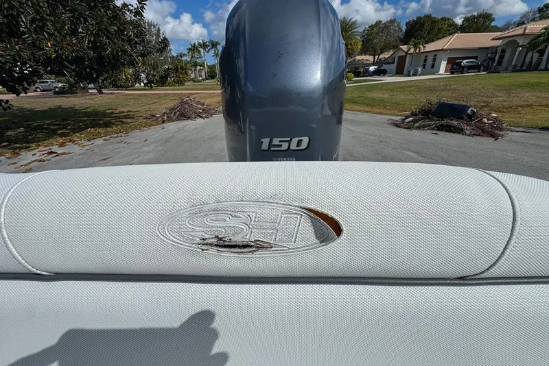 Slide: The Image of 2016 Sea Hunt Ultra 211 boat with Yamaha 150 engine, outdoor setting. - 99