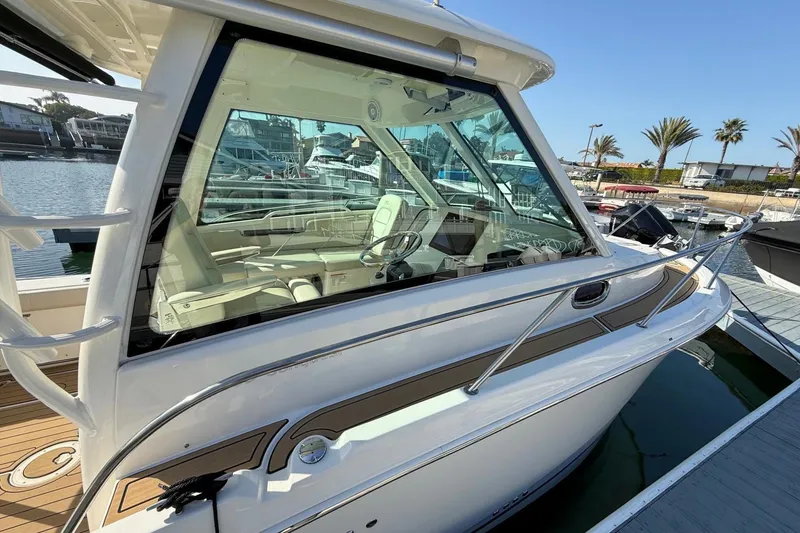 Slide: The Image of 2025 Boston Whaler 285 Conquest boat docked in a sunny marina. - 14