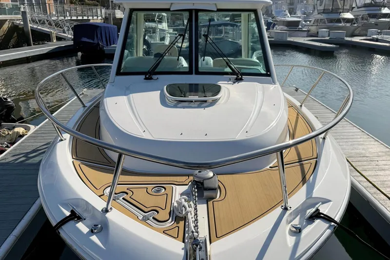 Slide: The Image of 2025 Boston Whaler 285 Conquest boat docked, showcasing sleek design and spacious deck. - 17