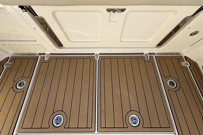 Slide: The Image of 2025 Boston Whaler 285 Conquest deck with sleek wood finish and secure latches. - 24