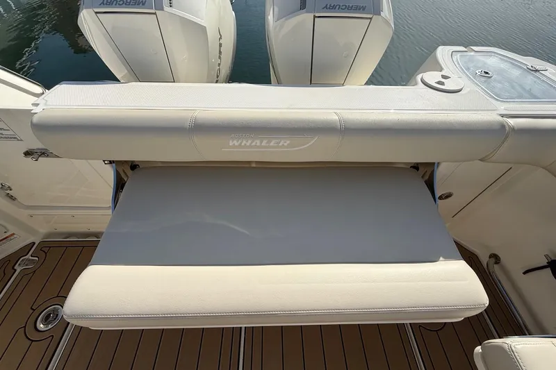 Slide: The Image of 2025 Boston Whaler 285 Conquest boat with Mercury engines and cushioned seating. - 25
