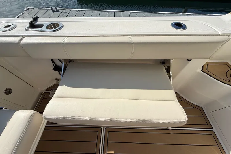 Slide: The Image of 2025 Boston Whaler 285 Conquest boat seat with cup holders and teak flooring. - 29