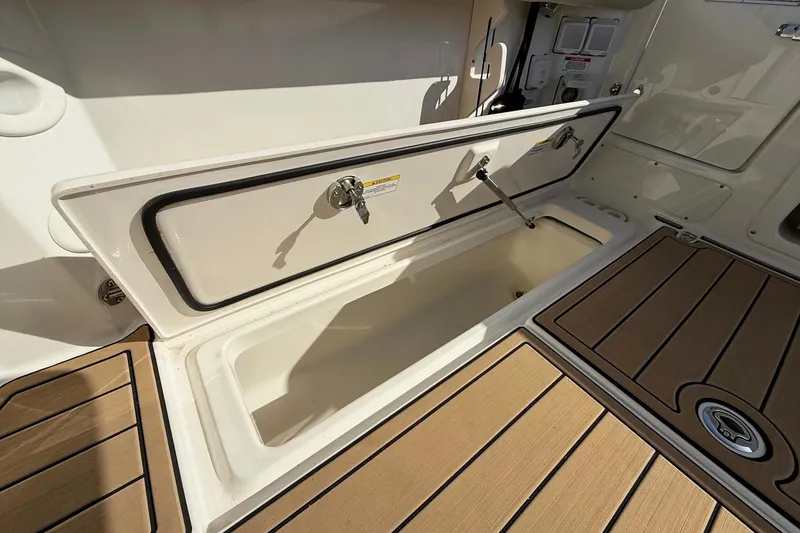 Slide: The Image of 2025 Boston Whaler 285 Conquest boat storage compartment with teak flooring. - 31