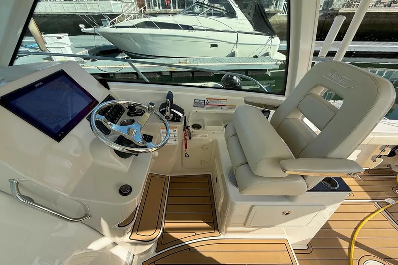 Slide: The Image of Helm of 2025 Boston Whaler 285 Conquest with modern controls and comfortable seating. - 37