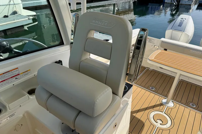 Slide: The Image of 2025 Boston Whaler 285 Conquest helm seat and deck, showcasing luxury marine design. - 41