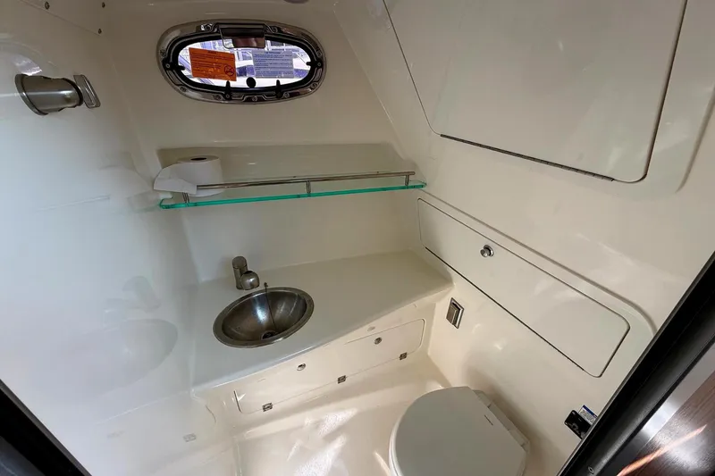 Slide: The Image of 2025 Boston Whaler 285 Conquest bathroom with sink, toilet, and window. - 47