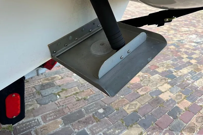 Slide: The Image of Trim tab of a 2004 Sea Ray 270 Sundeck on a brick-paved surface. - 16