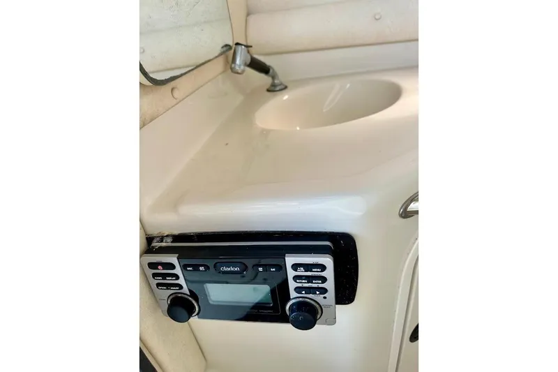 Slide: The Image of 2004 Sea Ray 270 Sundeck interior with sink and Clarion stereo system. - 30