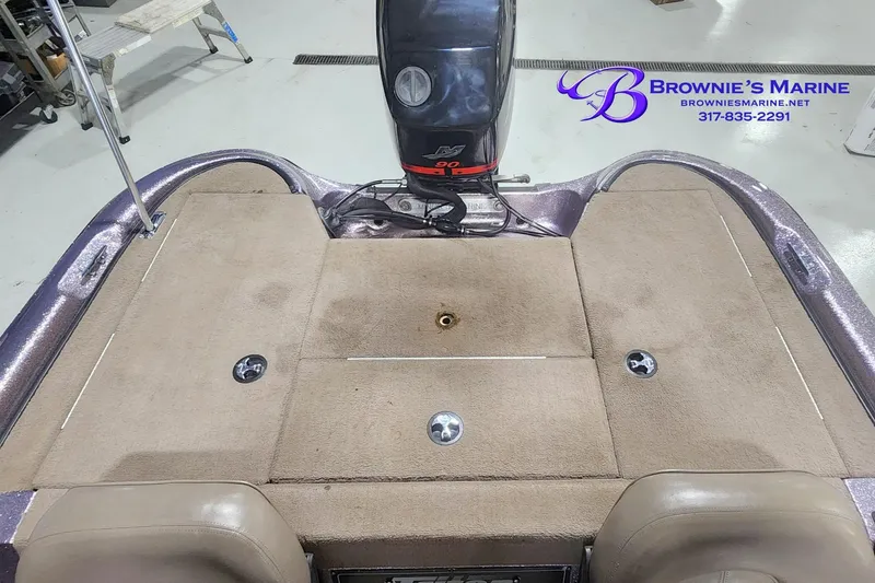 Slide: The Image of 2003 Triton Tr-165 boat interior with carpeted deck and outboard motor. - 10