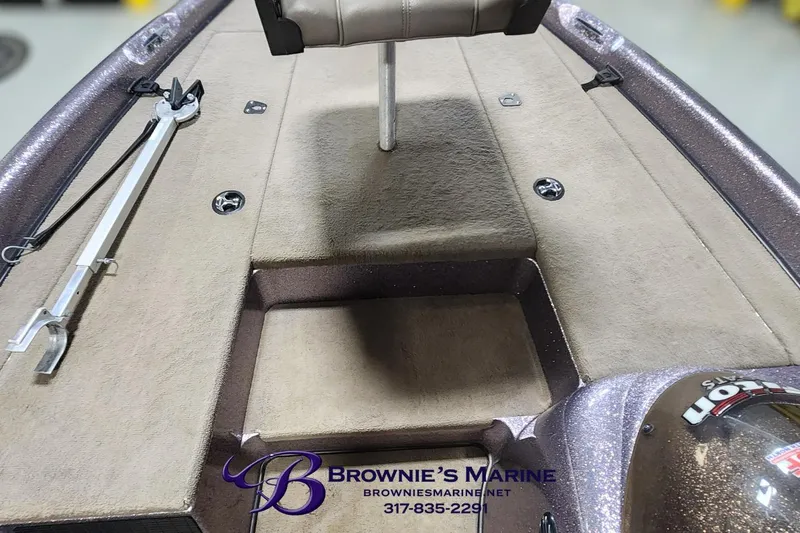 Slide: The Image of 2003 Triton Tr-165 boat interior with carpeted deck and seat, showcased by Brownie's Marine. - 5