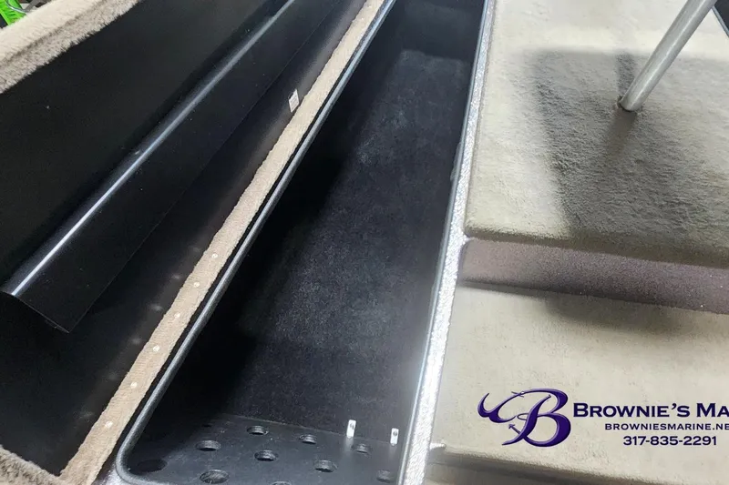 Slide: The Image of Triton Tr-165 boat storage compartment, 2003 model, with carpeted interior and Brownie's Marine logo. - 6