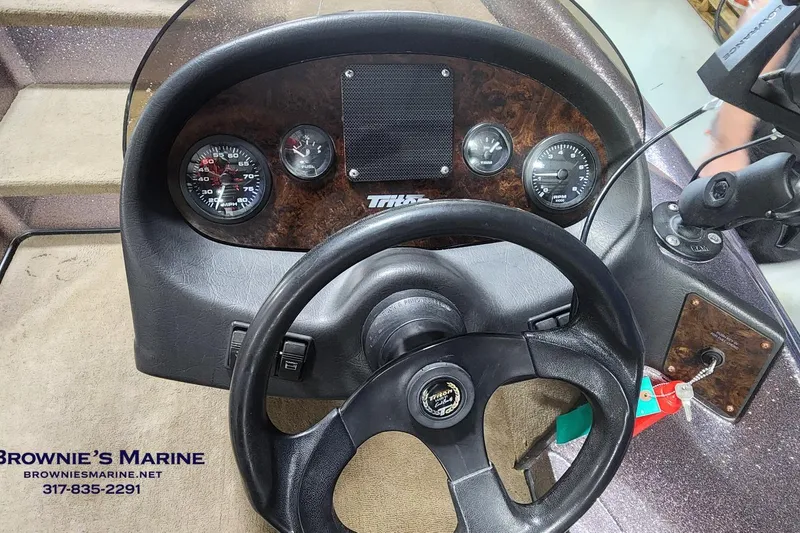 Slide: The Image of Dashboard of a 2003 Triton Tr-165 boat with steering wheel and gauges. - 8