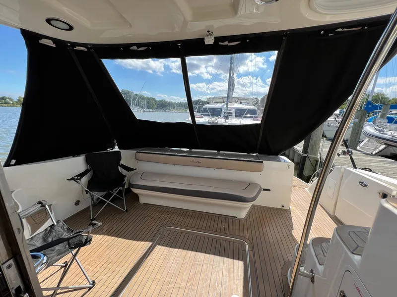 Slide: The Image of 2005 Sea Ray 500 Sedan Bridge interior with seating, docked at marina. - 11