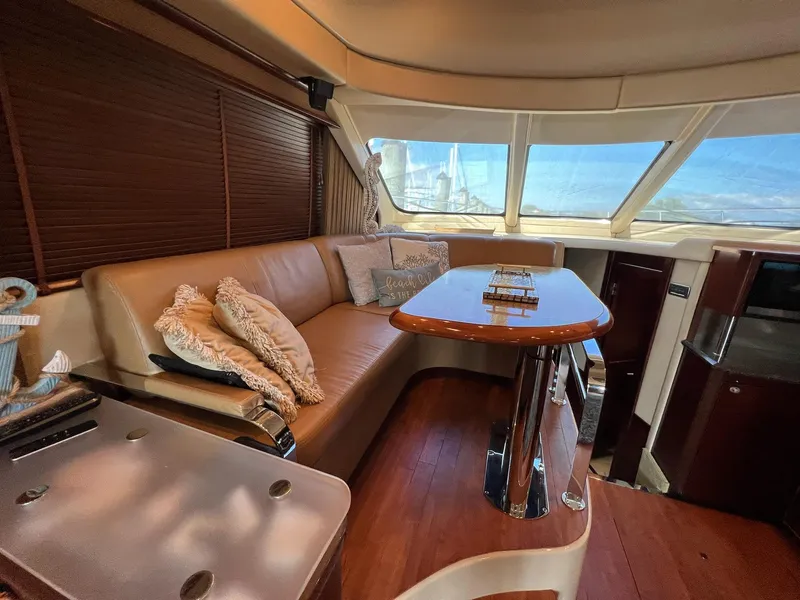 Slide: The Image of Luxurious interior of 2005 Sea Ray 500 Sedan Bridge yacht with plush seating and elegant table. - 13