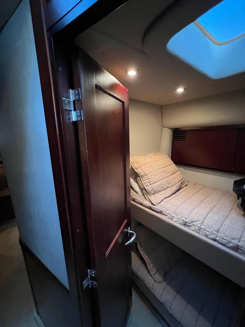 Slide: The Image of 2005 Sea Ray 500 Sedan Bridge cabin interior with bed and skylight. - 16