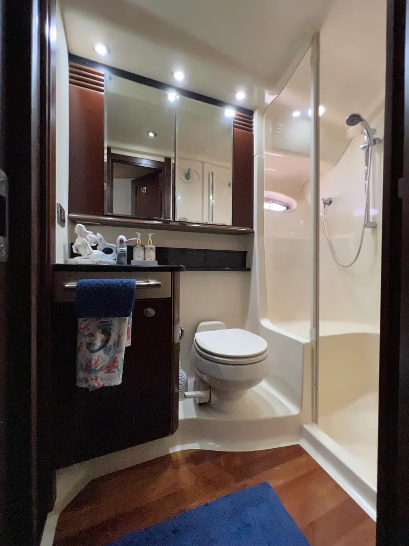 Slide: The Image of Luxurious bathroom in 2005 Sea Ray 500 Sedan Bridge yacht with shower and wooden accents. - 18