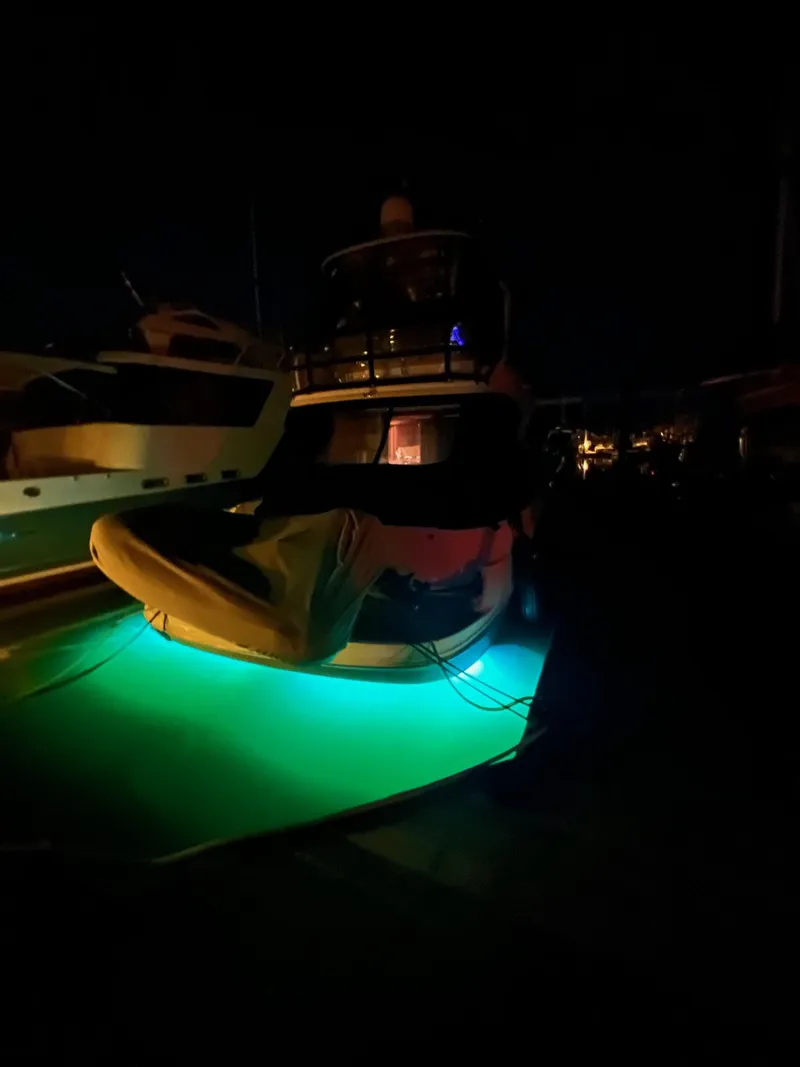 Slide: The Image of 2005 Sea Ray 500 Sedan Bridge with glowing underwater lights at night. - 2