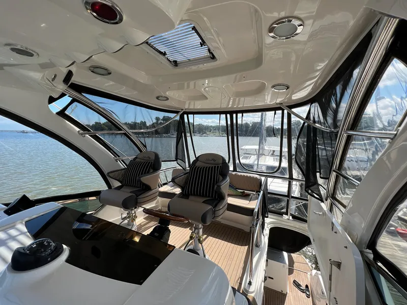 Slide: The Image of Interior of 2005 Sea Ray 500 Sedan Bridge yacht with panoramic windows and luxurious seating. - 27