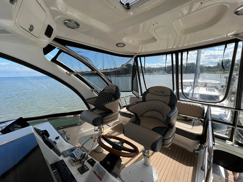 Slide: The Image of 2005 Sea Ray 500 Sedan Bridge helm with luxurious seating and panoramic water views. - 29