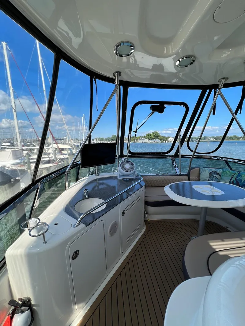 Slide: The Image of Interior of 2005 Sea Ray 500 Sedan Bridge yacht with seating and marina view. - 30