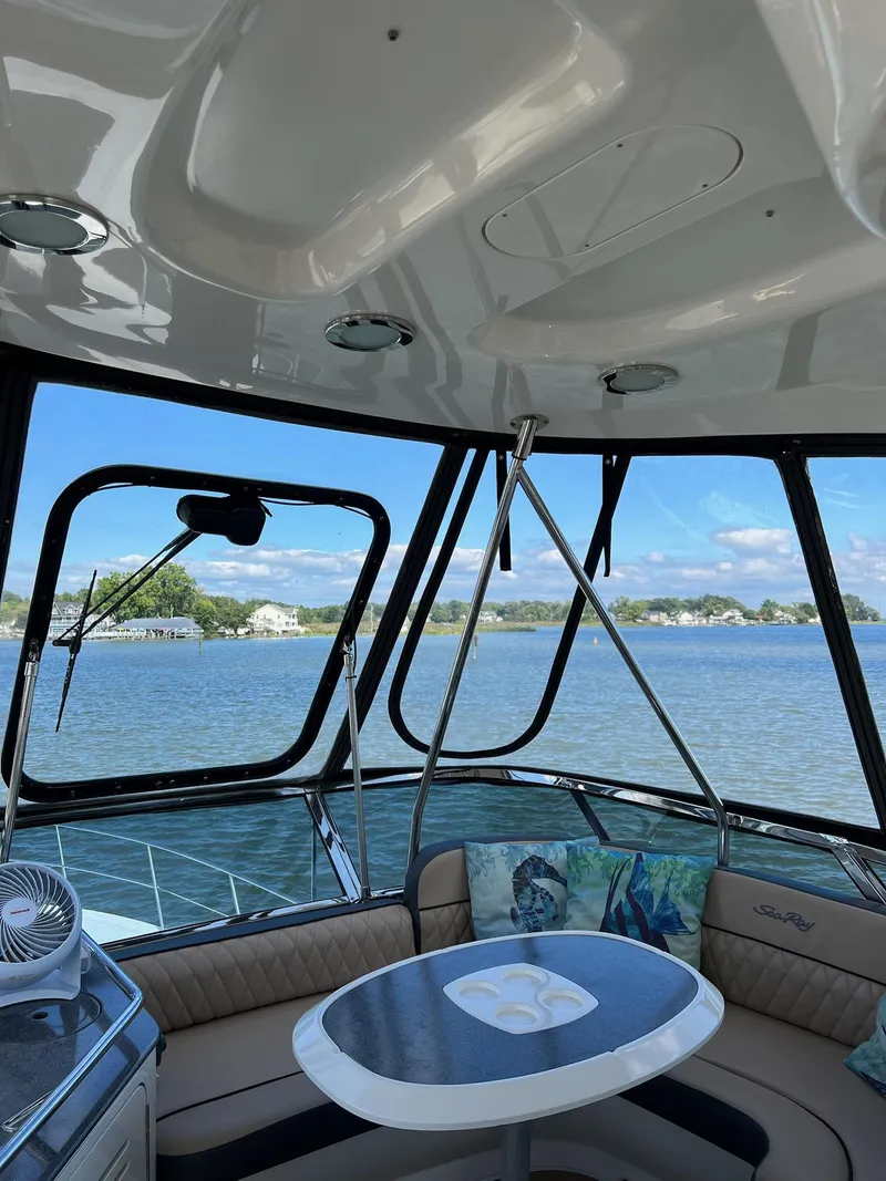 Slide: The Image of Interior view of 2005 Sea Ray 500 Sedan Bridge yacht with scenic water backdrop. - 32