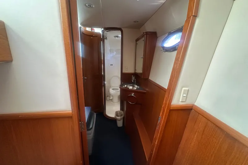 Slide: The Image of 2002 Wright Catamaran C50 Pilot House bathroom with wood paneling and compact design. - 10